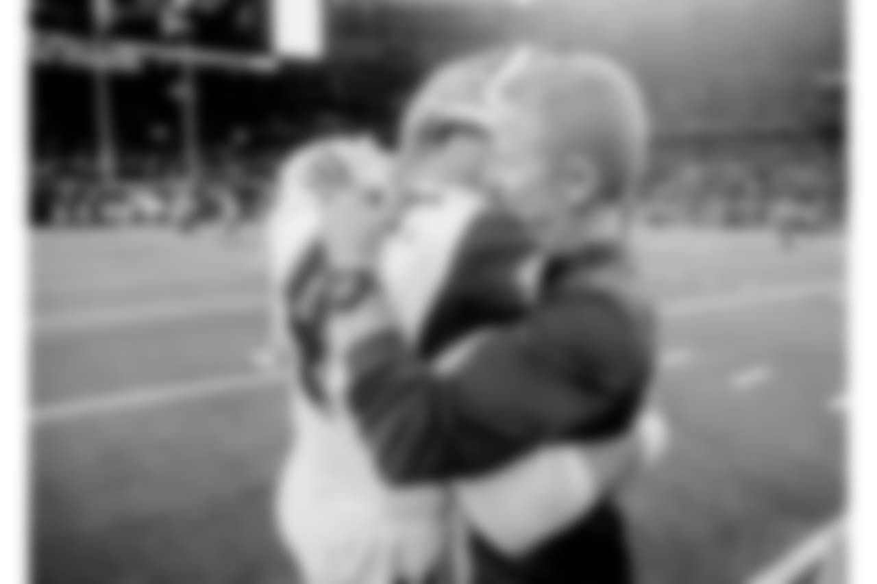 Dallas Cowboys quarterback Dak Prescott (4) and Dallas Cowboys head coach Jason Garrett embrace following their win over the New Orleans Saints in an NFL football game, in Arlington, Texas, Thursday, Nov. 29, 2018. Dallas won 13-10. (AP Photo/Michael Ainsworth)