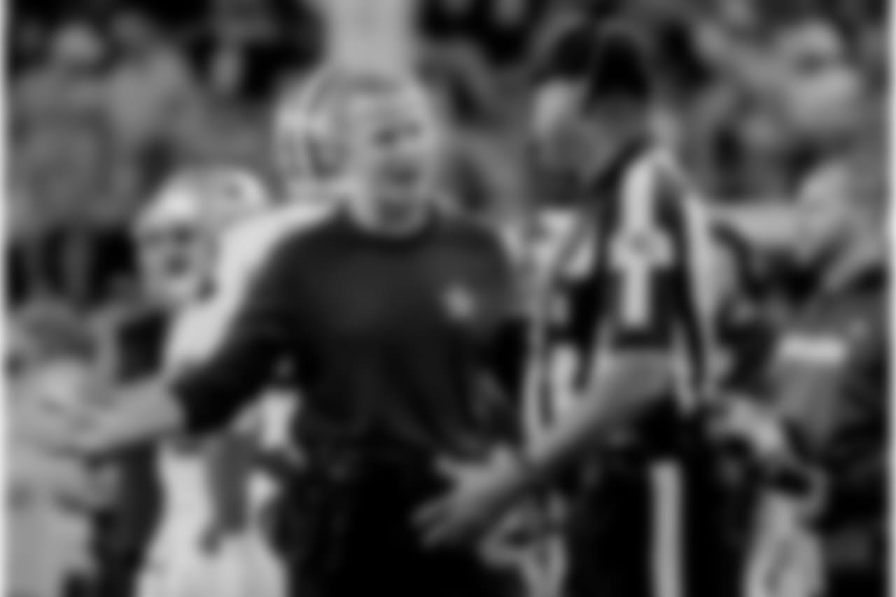 Dallas Cowboys head coach Jason Garrett, left, questions a call in the first half of an NFL football game, in Arlington, Texas, Thursday, Nov. 29, 2018. (AP Photo/Roger Steinman)