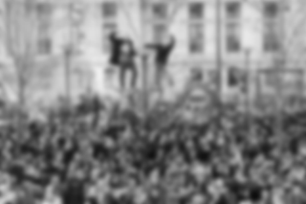 Fans even climbed poles to get a good view of the parade.