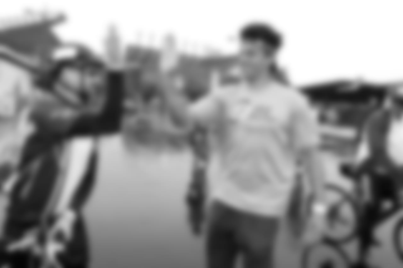WR Mack Hollins high-fives a fan.