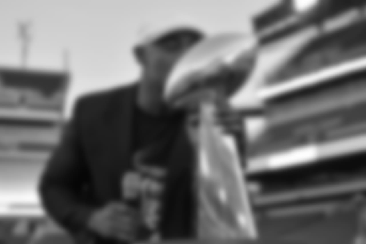 Brian Dawkins plants a big kiss on the Vince Lombardi Trophy.