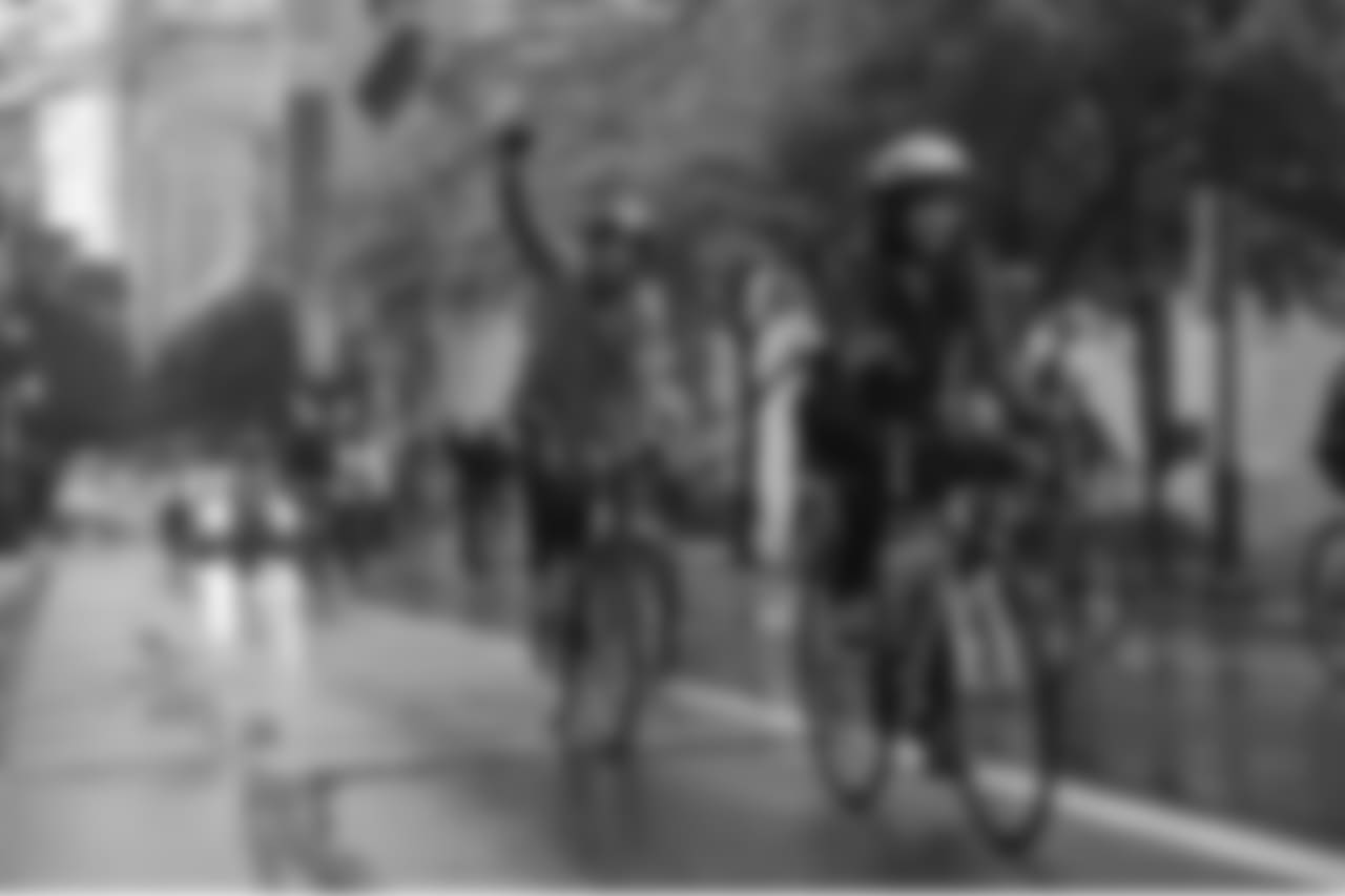 A rider pumps his fist.