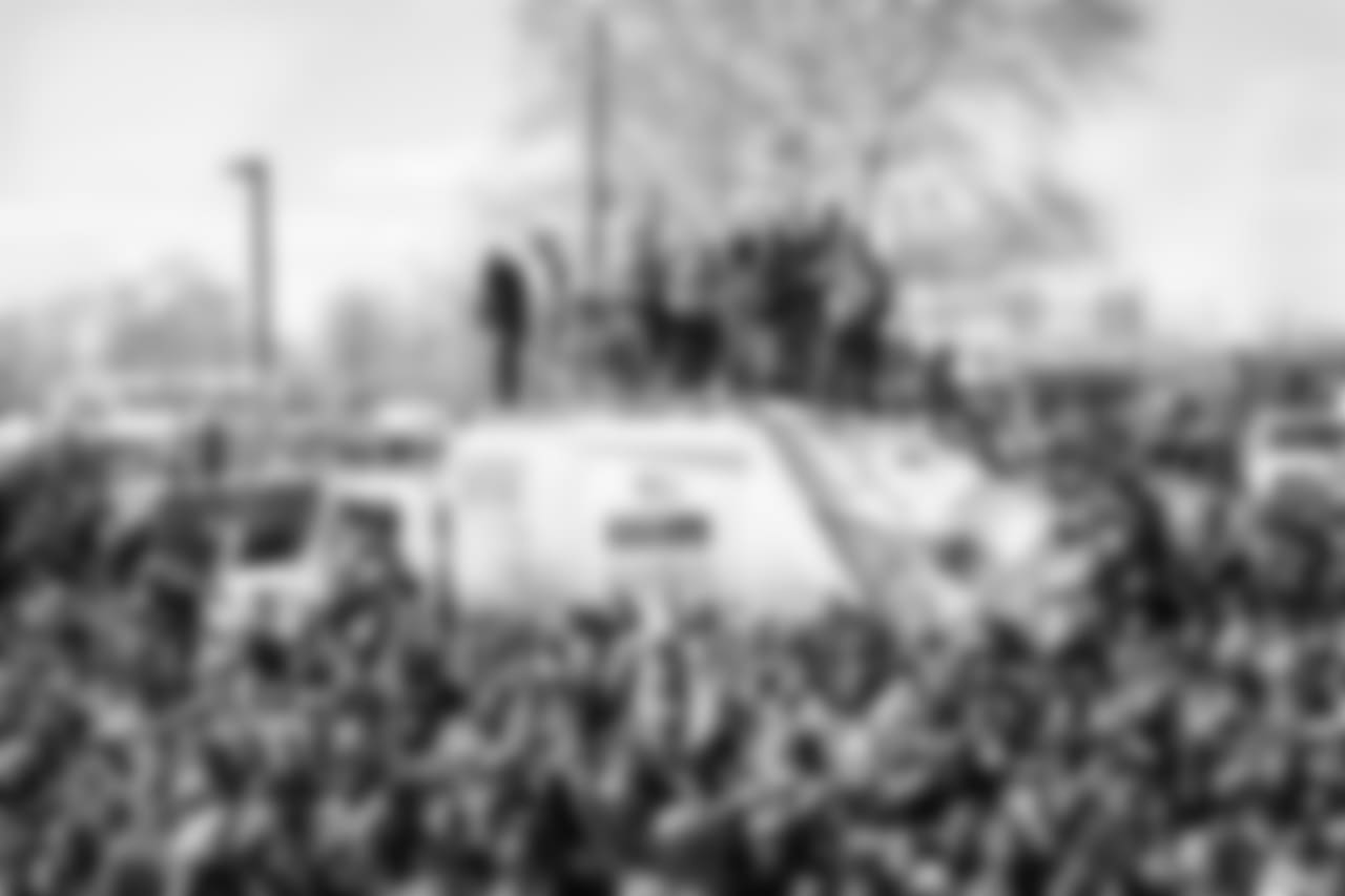 These fans climbed on top of a garbage truck to get a better view.