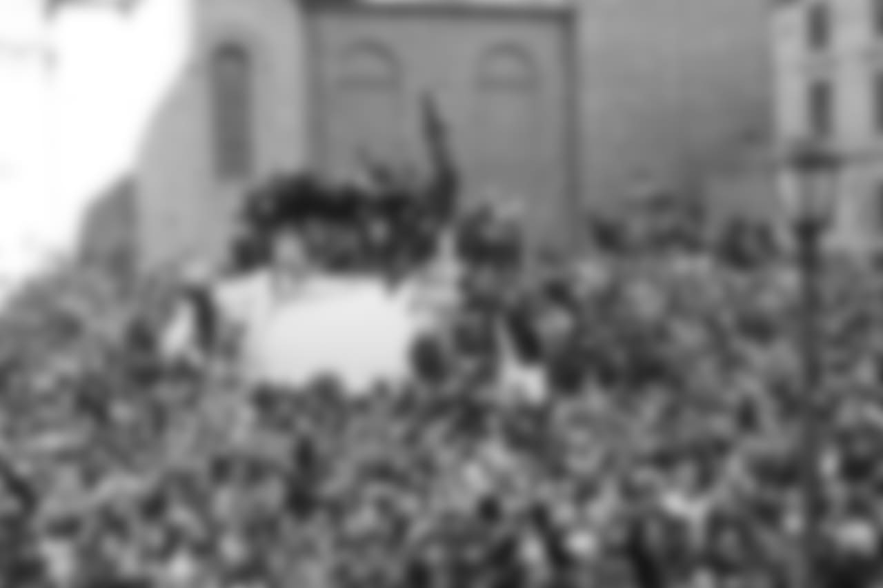 More fans climbing on garbage trucks.