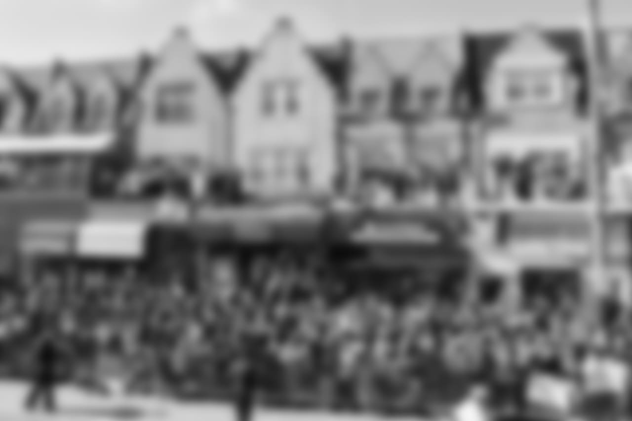Fans climbed atop many rooftops to see the parade.
