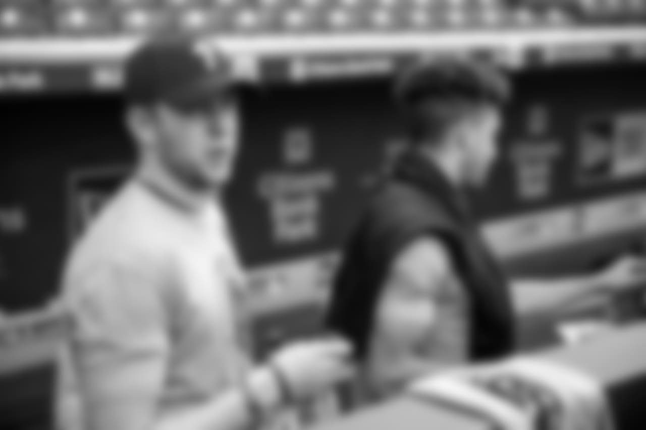 QB Nate Sudfeld and Hollins watch from the dugout