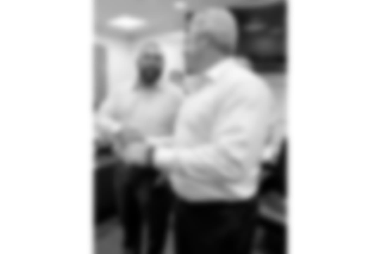 Defensive line coach Chris Wilson congratulates Doug Pederson on the selection