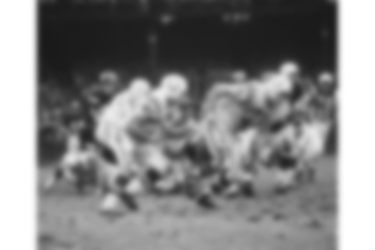 Baltimore Colts Dan Sullivan (71) lead blocks for Jerry Hill (45) during a game agains the New York Giants on November 3,1968 at Yankee Stadium in the Bronx, New York. The Baltimore Colts beat the New York Giants 26-0. John Williams played for 12 years, with 2 different teams.(David Durochik via AP)