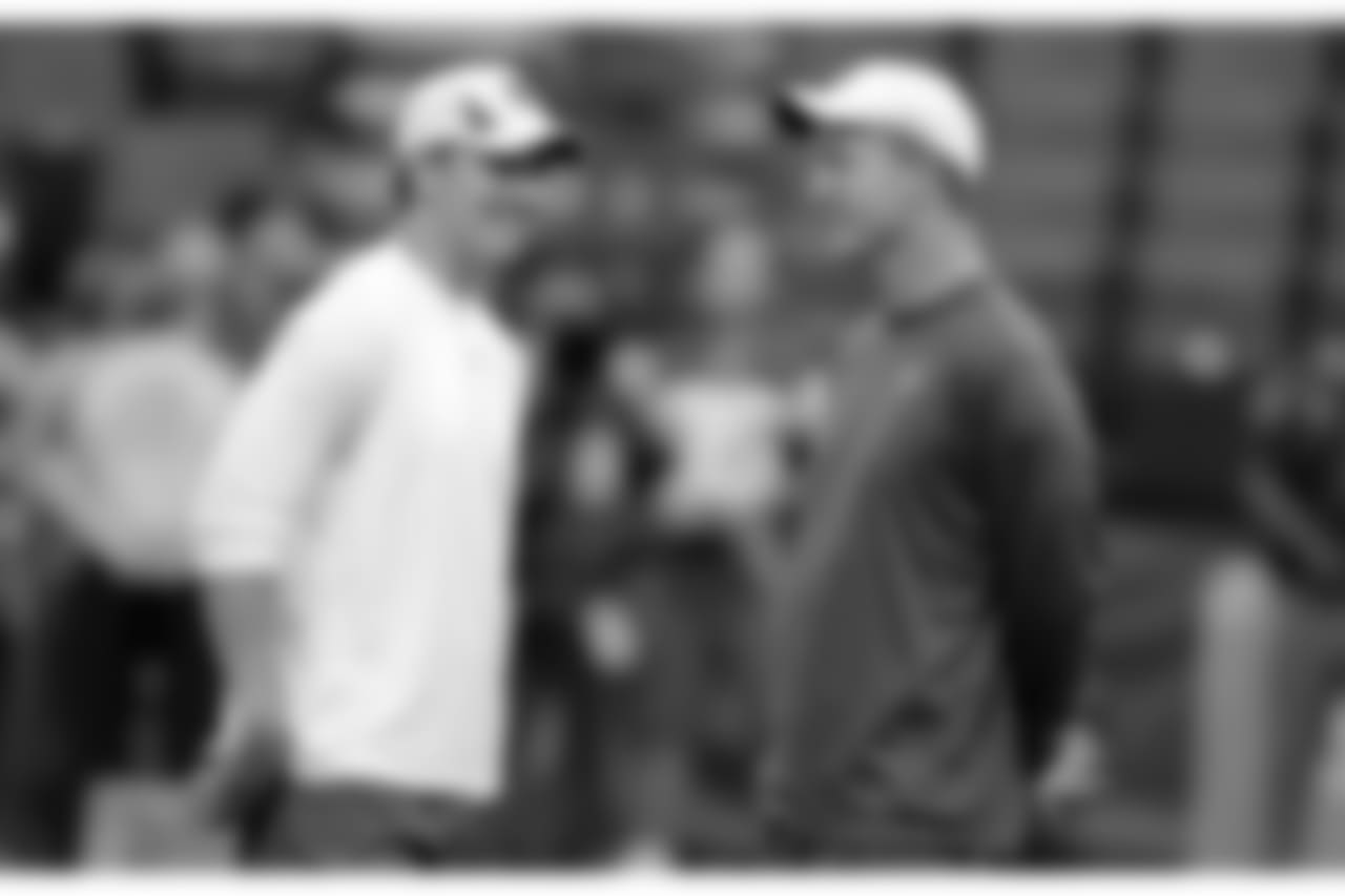 FILE - This Sept. 19, 2010 file photo shows New York Giants quarterback Eli Manning, left, talking with his brother, Indianapolis Colts quarterback Peyton Manning, before an NFL football game in Indianapolis. Eli says he didn't want to host "Saturday Night Live" after his first Super Bowl victory because it came so soon after big brother Peyton's appearance a year earlier. He sent word back to the show's executives that perhaps he'd host if he won another championship. Sure enough, the Giants quarterback said yes after his second title and will star in the comedy sketches Saturday. (AP Photo/Darron Cummings, File)