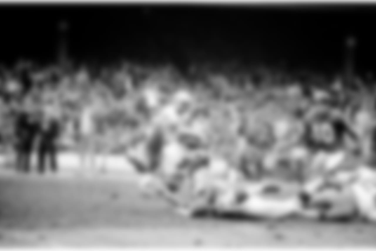 Cliff Harris (43) of the Dallas Cowboys is upended returning a punt by the New York Giants during the second quarter at Yankee Stadium in New York, Dec. 13, 1971. Making the tackle is the Giants' Ralph Heck (55). In the background is Cowboy Claxton Welch. The Cowboys routed the Giants 42-14. (AP Photo/Ray Stubblebine)