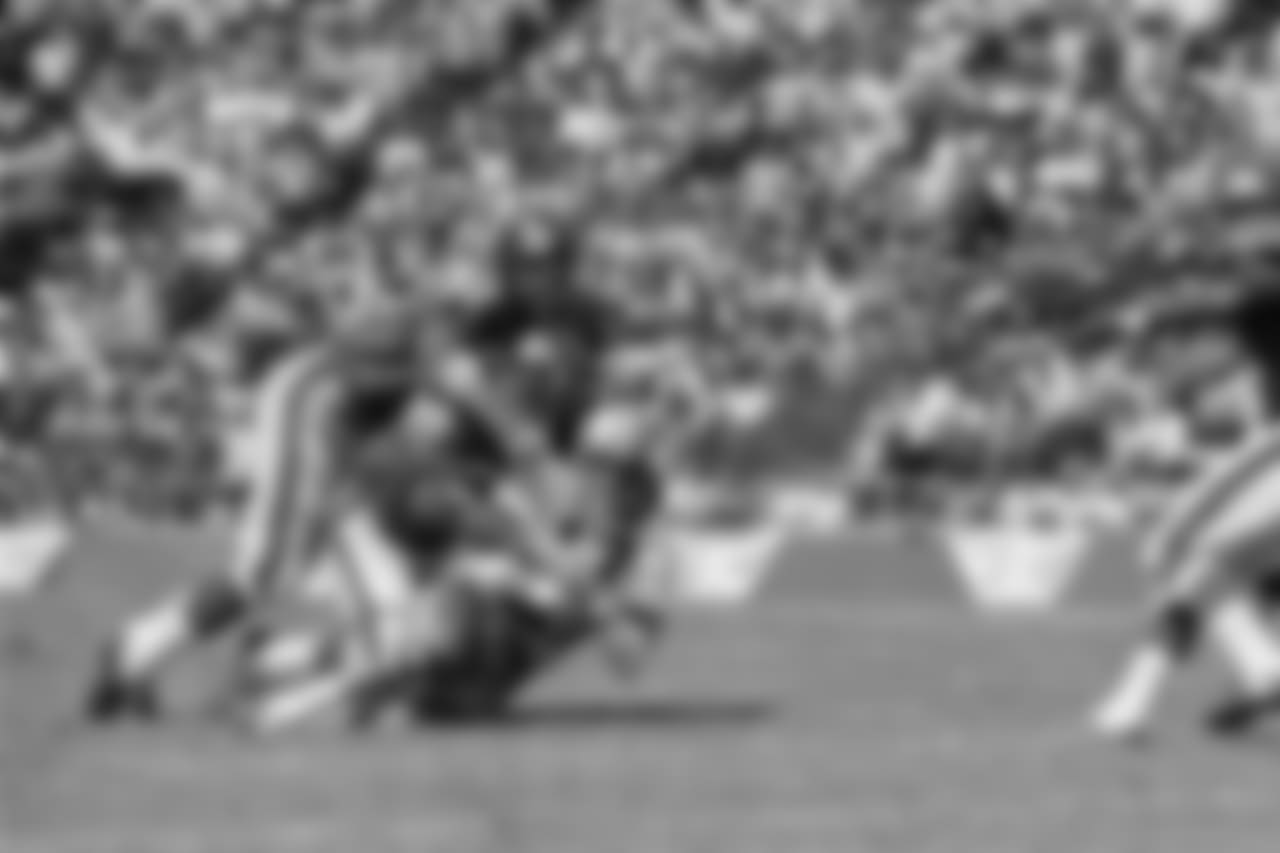 Dallas Cowboy quarterback Don Meredith (17) is tackled after an 8-yard run in the second quarter of Sunday's game at the Cotton Bowl against the New York Giants September 24, 1967. Making the tackle are Giant Linebackers Bill Swain (52) and Vince Costello (57). Meredith led the cowboys to a 38-24 victory over the Giants. (AP Photo)
