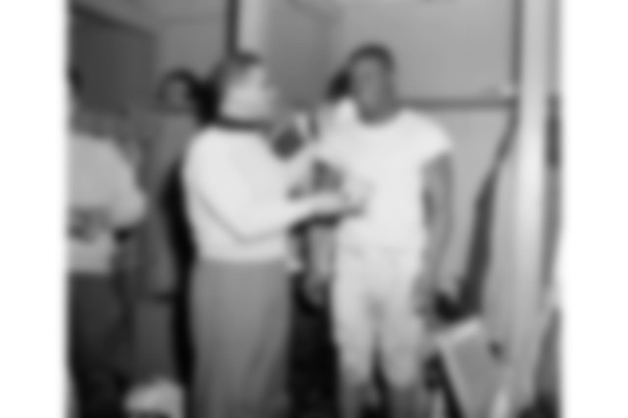 Giants backfield coach Vince Lombardi, left, admiring watch presented to Mel Triplett, right, for his play football title game against the Chicago Bears in New York, Dec. 31, 1956. (AP Photo/Tom Fitzsimmons)