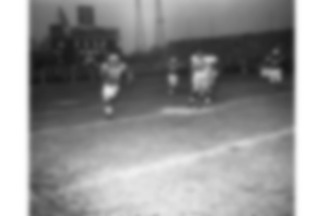 John Sample, Baltimore Colts' defensive star, takes off toward the goal after the second of his fourth quarter interceptions of the New York Giant passes in Baltimore, Md., Dec. 27, 1959. No. 55 is Ray Wietecha of the Giants and no.52 is Dick Syzmanski of the Colts.Sample's pass interceptions--one for a touchdown--helped the colts defeat the Giants, 31-16, in the National League title game. (AP Photo)