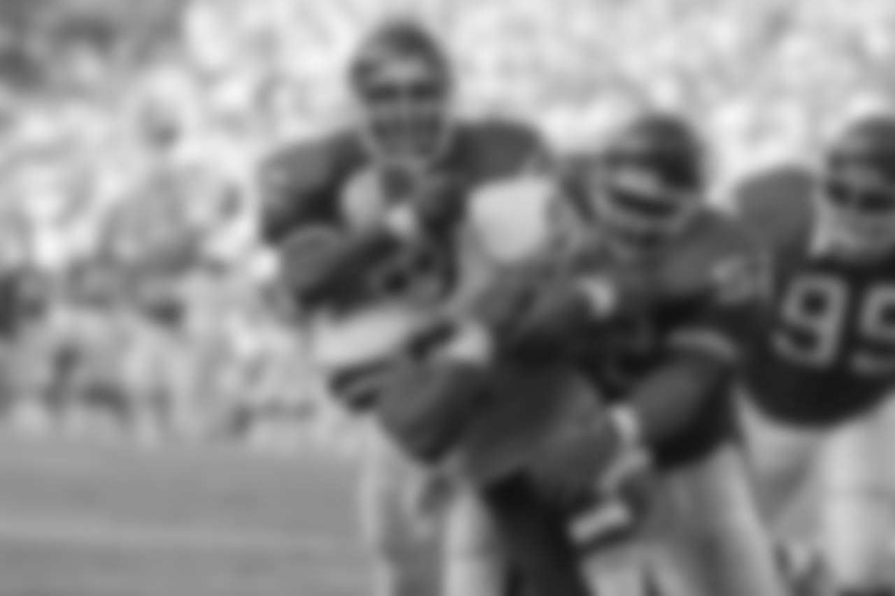 Washington Redskins running back Earnest Byner (21) is tackled by New York Giants defenders Lawrence Taylor (56) and Pepper Johnson (52) during first quarter NFL action at RFK Stadium in Washington, D.C., Sunday, Oct. 14, 1990. (AP Photo/Doug Mills)