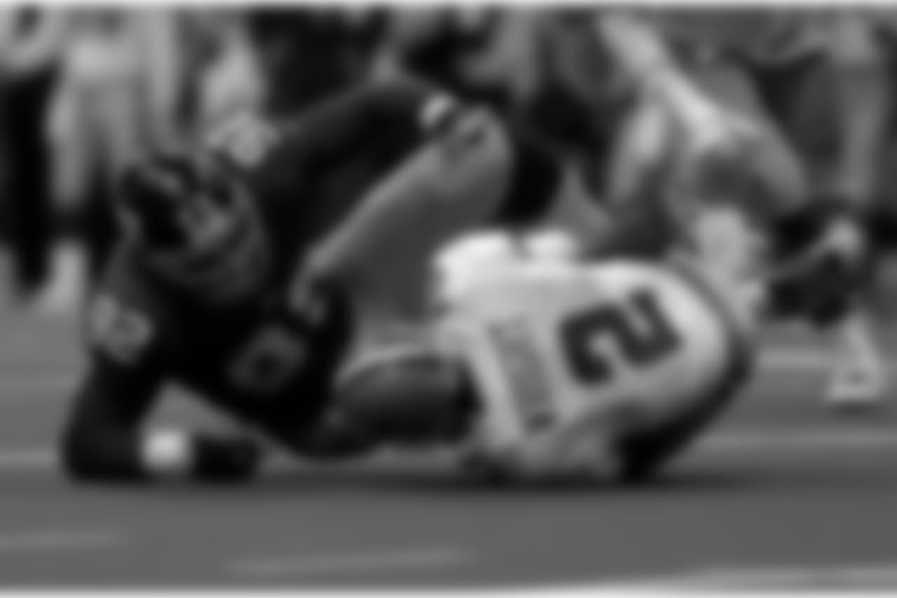 Dallas Cowboys quarterback Anthony Wright (2) hits the ground after being sacked by New York Giants defensive end Michael Strahan in the fourth quarater Sunday, Dec. 17, 2000 in Irving, Texas. (AP Photo/Donna McWilliam)