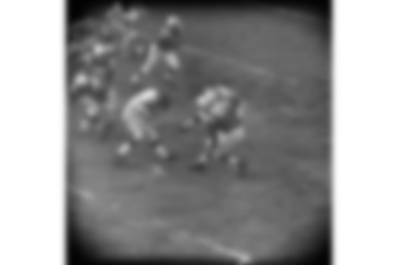Phil King (24) of the New York Giants carries the ball against the Baltimore Colts on a kickoff return in the first quarter at Baltimore, Dec. 27, 1959. Colts at right are Sherman Plunkett (79) and Ed Cooke (85). (AP Photo)