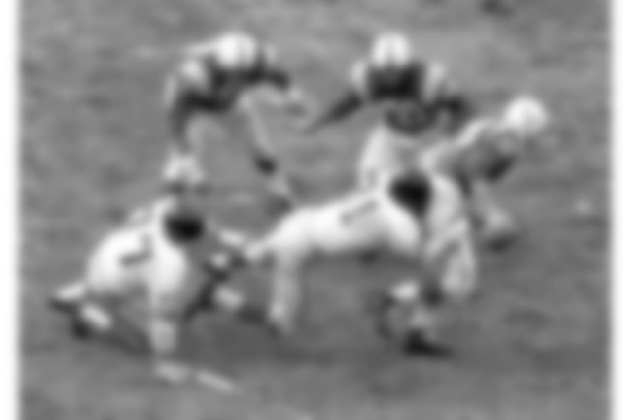 Baltimore Colts' quarterback Johnny Unitas (19 ) is rushed and pulled down by Andy Robustelli (81) New York Giants end Dec.27,1959. Tackle came in second quarter of championship game in Baltimore, Md, as Unitas tried to pass. Other players are not identified. (AP Photo)