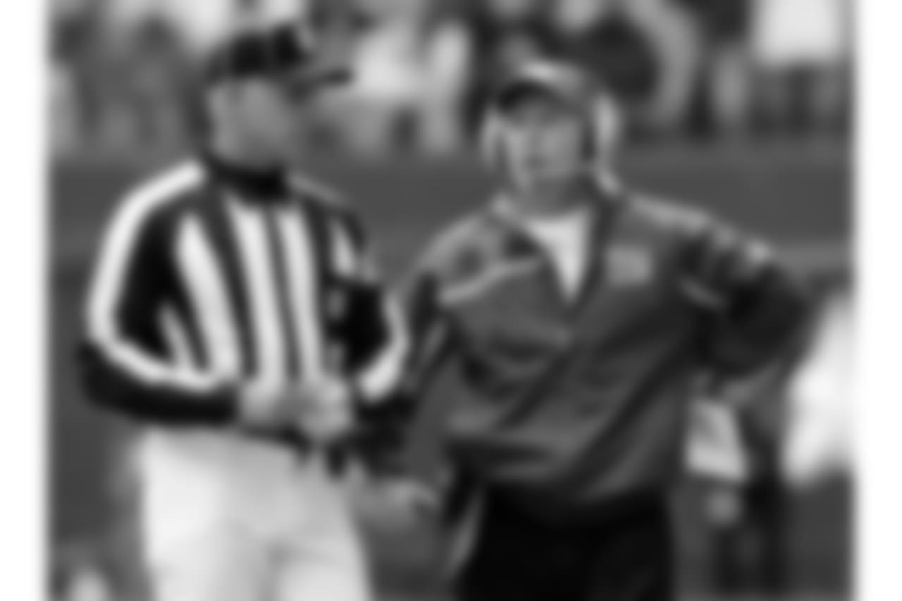 New York Giants head coach Tom Coughlin, right, talks with an official as he calls for a review of a play against the Dallas Cowboys in the second quarter of an NFC divisional playoff football game, Sunday, Jan. 13, 2008, in Irving, Texas. (AP Photo/Tony Gutierrez)