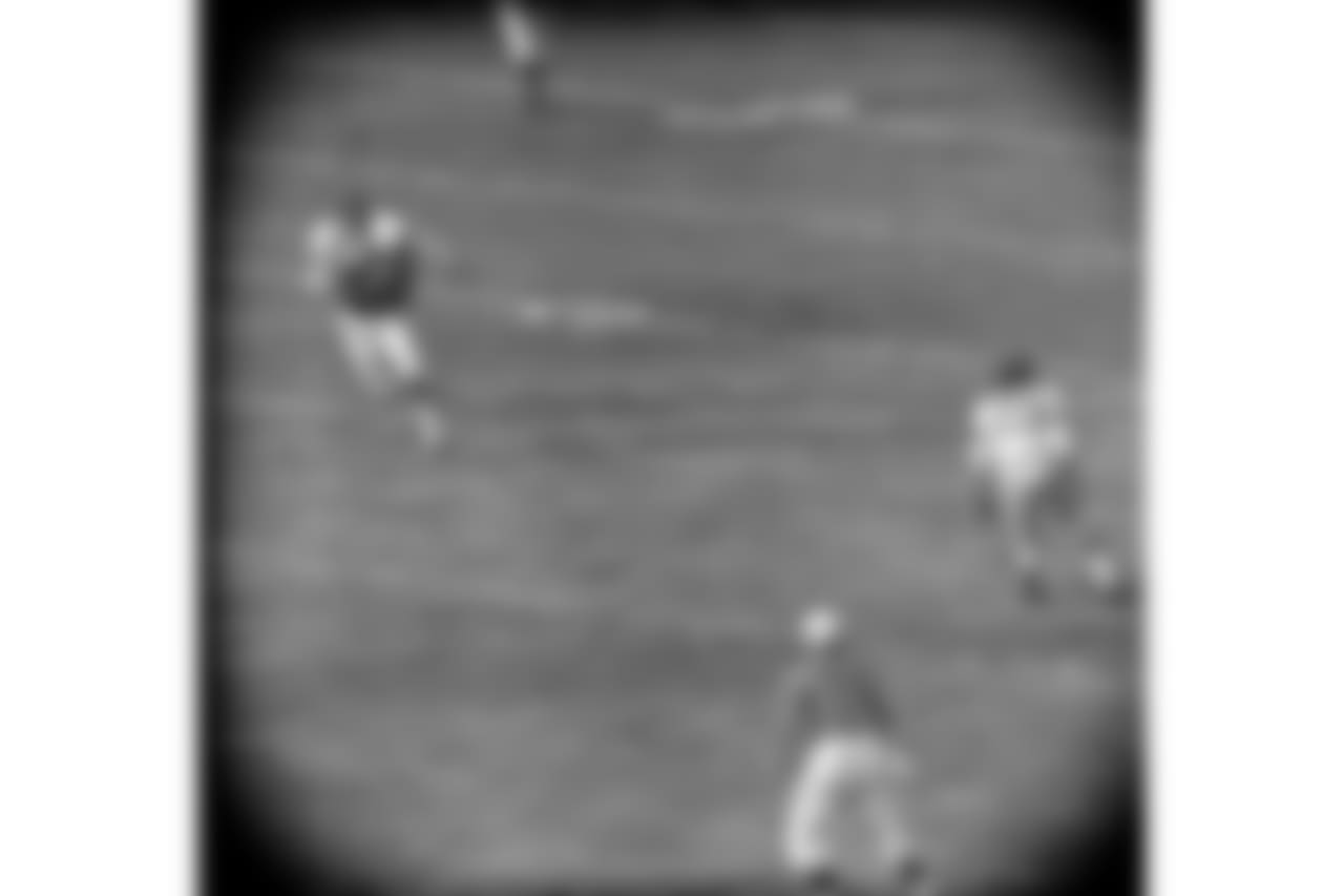 Lennie Moore (24) of the Baltimore Colts catches a pass from Johnny Unitas in behind Linden Crow (41) of the New York Giants during the first quarter of play in New York, Dec. 27, 1959. Dick Nolan (25) of the Giants looks on. The play was good for a total of 60 yards and a touchdown in the first quarter. (AP Photo/Harry Harris)