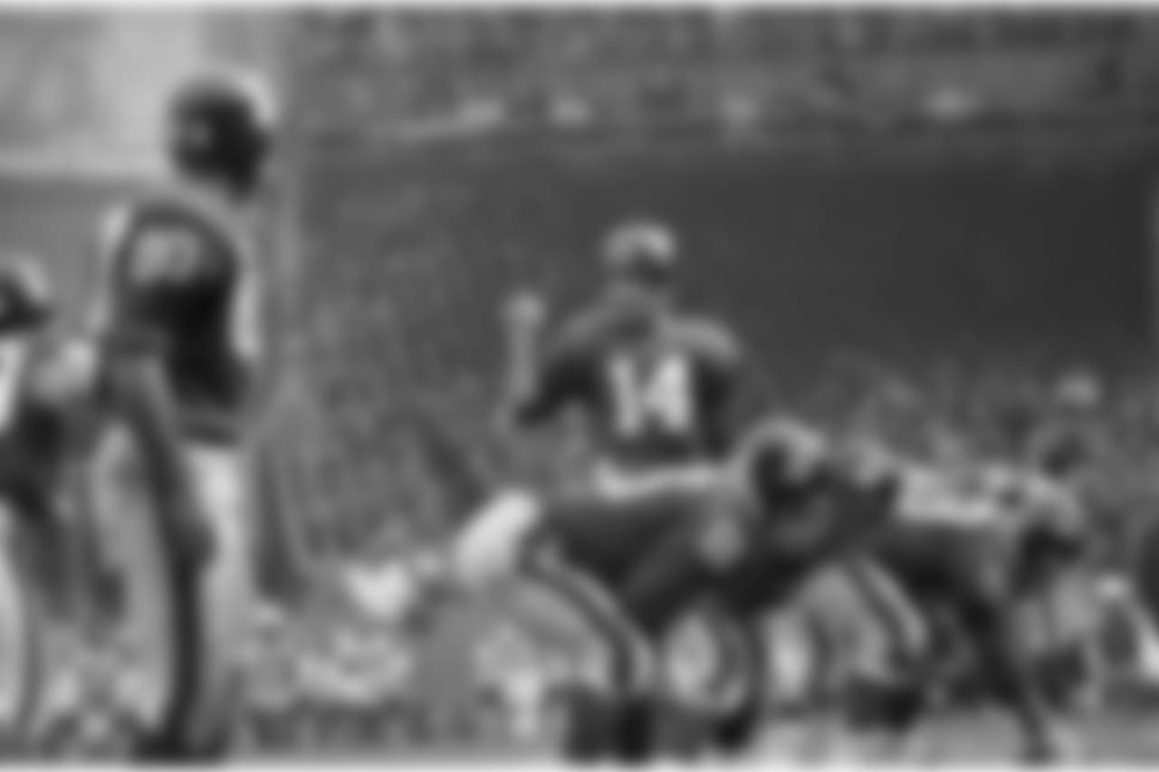 Y.A. Tittle, quarterback of the N.Y. Giants, directs a last minute shift in strategy as the Giants line crouches to engage the Dallas Cowboys, Nov. 12, 1963. (AP Photo/Ruben Goldberg)