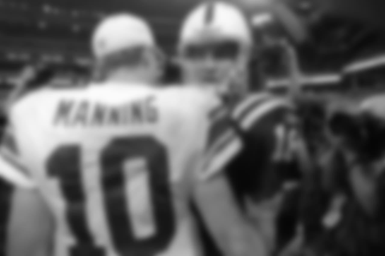 Indianapolis Colts quarterback Peyton Manning, right, greets his brother New York Giants quarterback Eli Manning following an NFL football game in Indianapolis, Sunday, Sept. 19, 2010. Indianapolis won 38-14. (AP Photo/Darron Cummings)