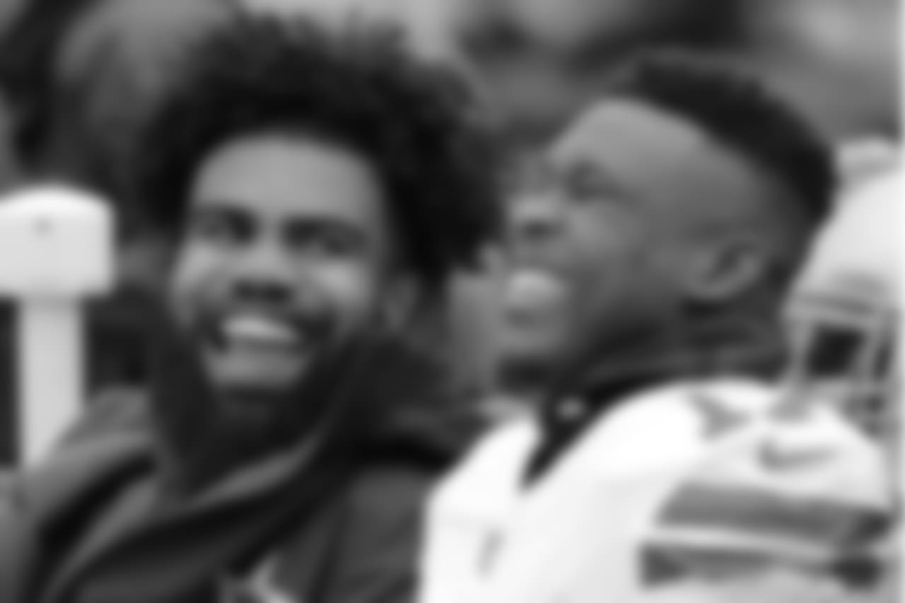 Dallas Cowboys' Ezekiel Elliott, left, talks with Allen Hurns during the first half of an NFL football game against the New York Giants, Sunday, Dec., 30, 2018, in East Rutherford, N.J. (AP Photo/Frank Franklin II)
