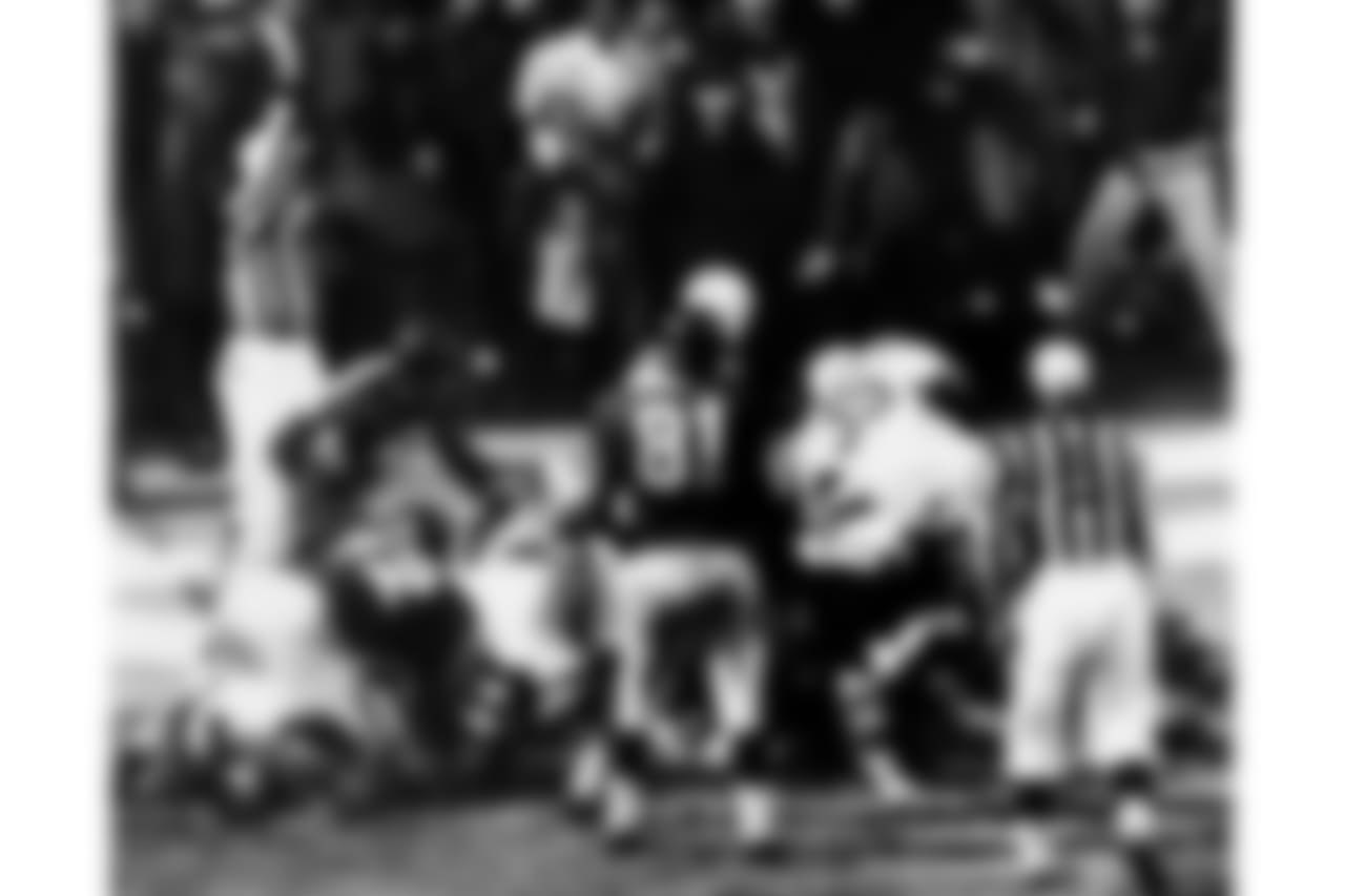 Baltimore Colt fullback Alan Ameche plunges thru a hole to score the winning touchdown in the NFL Championship game against the New York Giants, Dec. 28, 1958 in New York. (AP Photo)