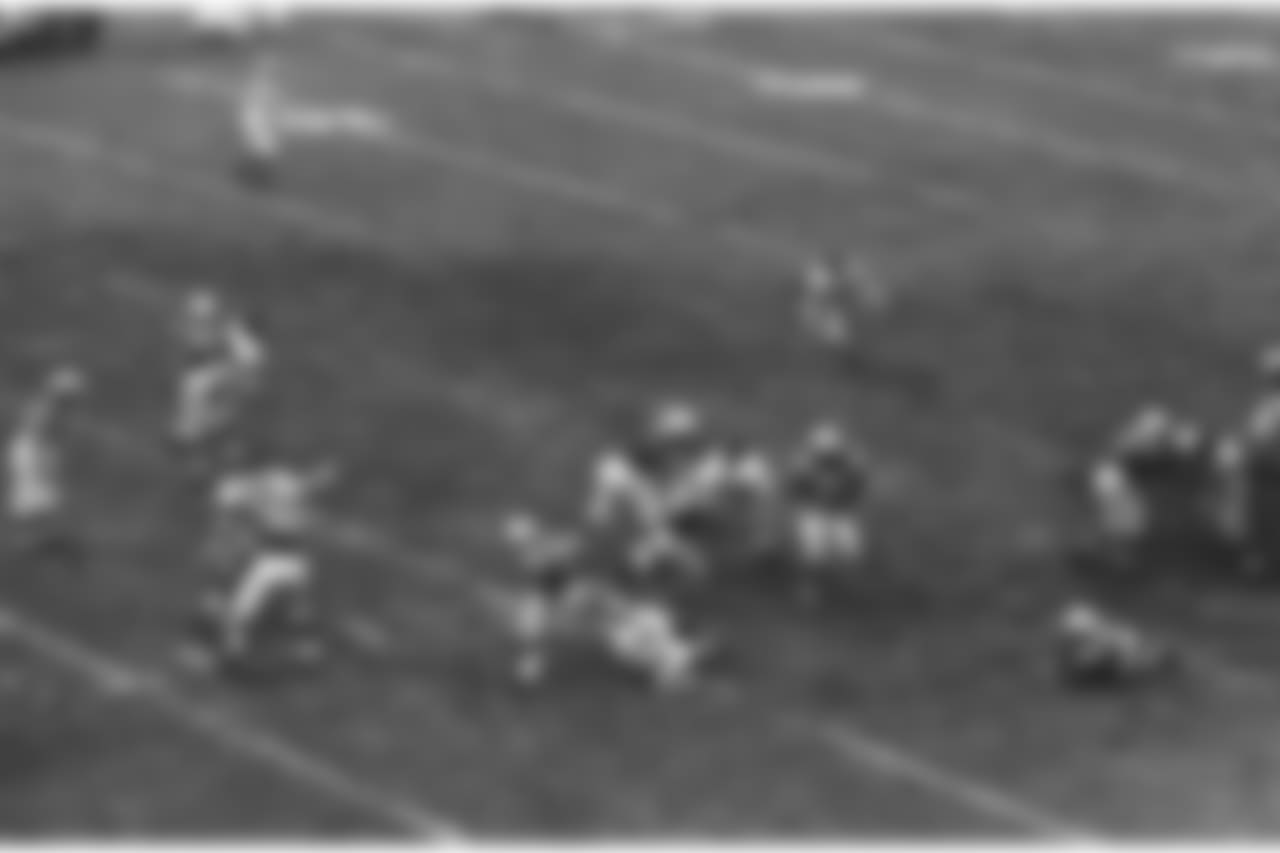 Johnny Unitas, (19), quarterback of the Baltimore Colts is rushed and pulled down by Andy Robustelli, 81, New York Giants end, as he tries to pass in the second quarter of championship game on Dec. 27, 1959 in Baltimore. (AP Photo)