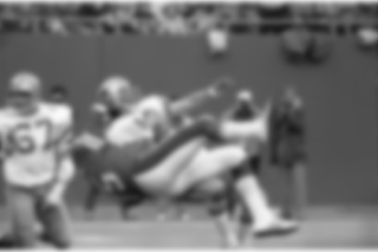New York Giants defensive end George Martin flips Dallas Cowboys quarterback Roger Staubach for a loss in the fourth quarter of game, Nov. 5, 1979 at Giants Stadium in East Rutherford, N.J. Tough pressure by the Giants almost gave them a victory, but the Cowboys won 16-14 on a last minute field goal. (AP Photo/Ray Stubblebine)