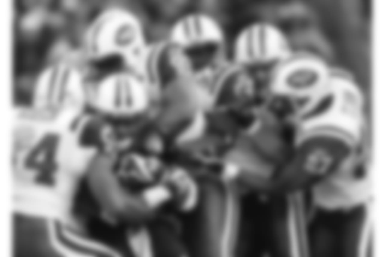 Tennessee Titans running back LenDale White, second from left, is stopped by New York Jets linebacker Victor Hobson (54) and a quartet of teammates in the first quarter of an NFL football game in Nashville, Tenn., Sunday, Dec. 23, 2007. Also in on the stop are Jets' C. J. Mosley (95), David Harris (52), Mike DeVito, second from right, and Abram Elam (27). (AP Photo/Mark Humphrey)