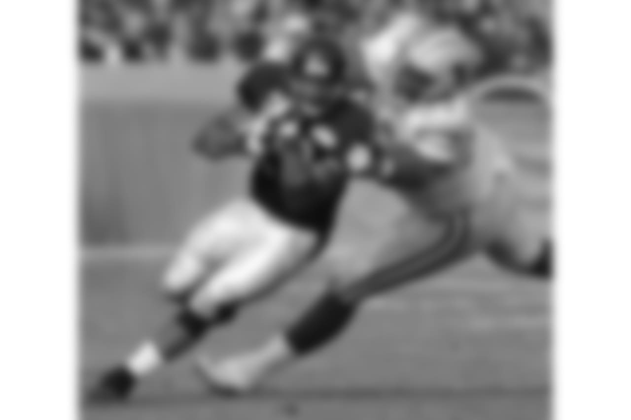 Chicago Bears' James Allen (20) tries to turn upfield while being pursued by Detroit Lions' Shaun Rogers (92) during the first half at Soldier Field in Chicago, Sunday, Dec. 2, 2001. (AP Photo/Stephen J. Carrera)