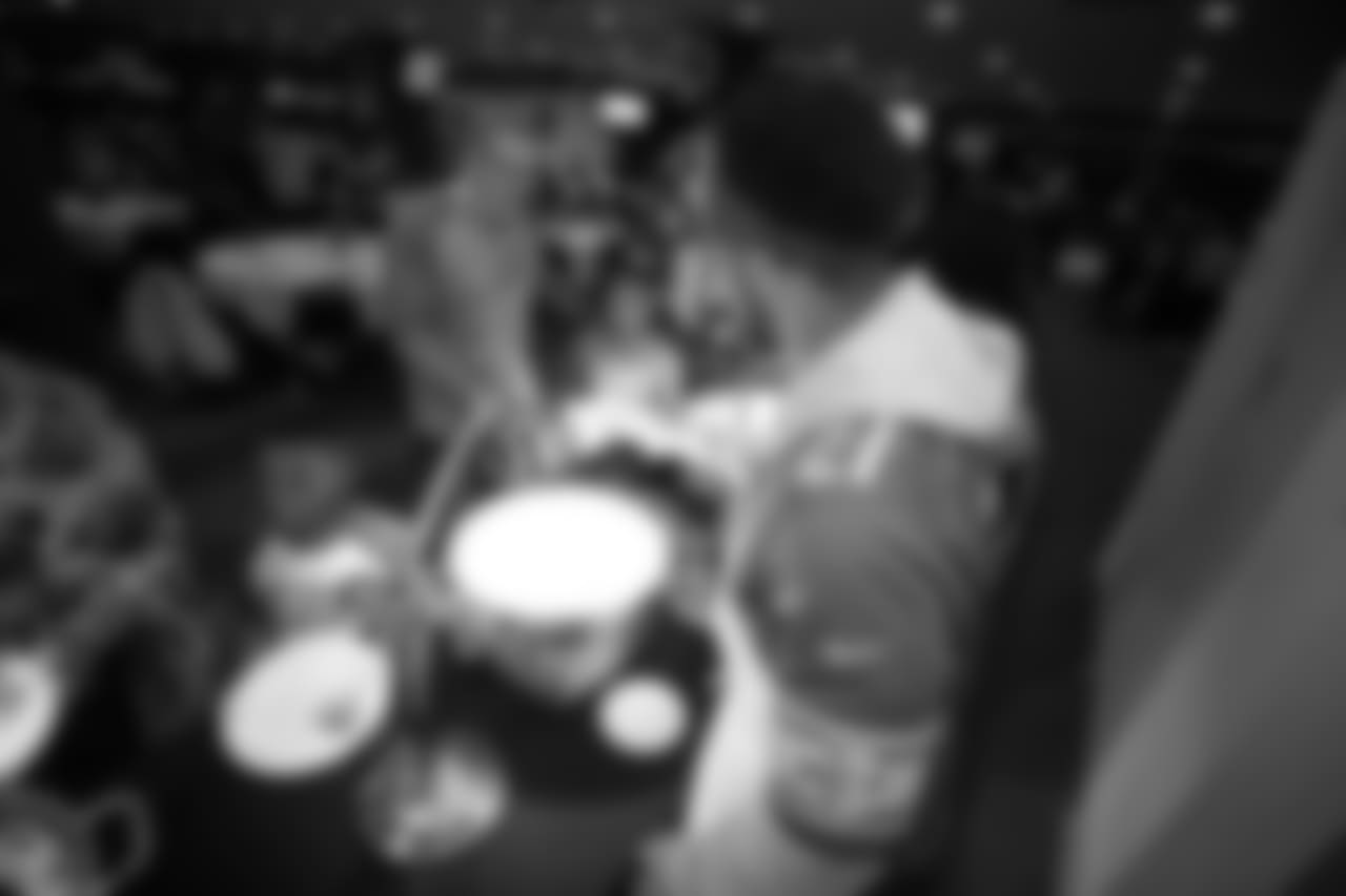 Detroit Lions safety Glover Quin (27) serves food at the annual Thanksgiving Dinner at Ford Field with families from Orchards, Children’s Center and Yatooma as part of the Season of Sharing campaign presented by Meijer.