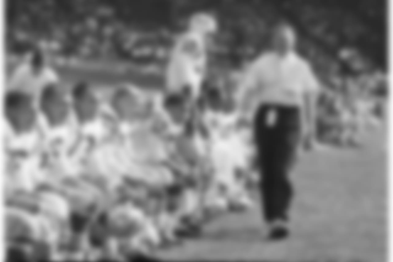 Jack Christiansen, new head coach of the San Francisco 49ers, pacing in front of the bench as his former teammates, the Detroit Lions, were polishing of an easy 26-3 win in Detroit, Oct. 6, 1963. Standing is end Bernie Casey (30). (AP Photo/Alvan Quinn)
