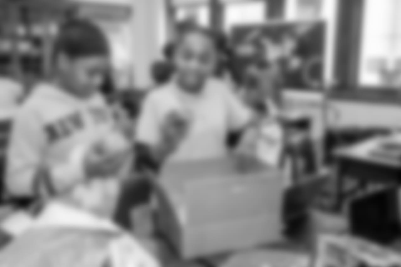 Students at Mary McLeod Bethune Elementary-Middle School open gifts on Tuesday, Dec. 18, 2018 in Detroit.