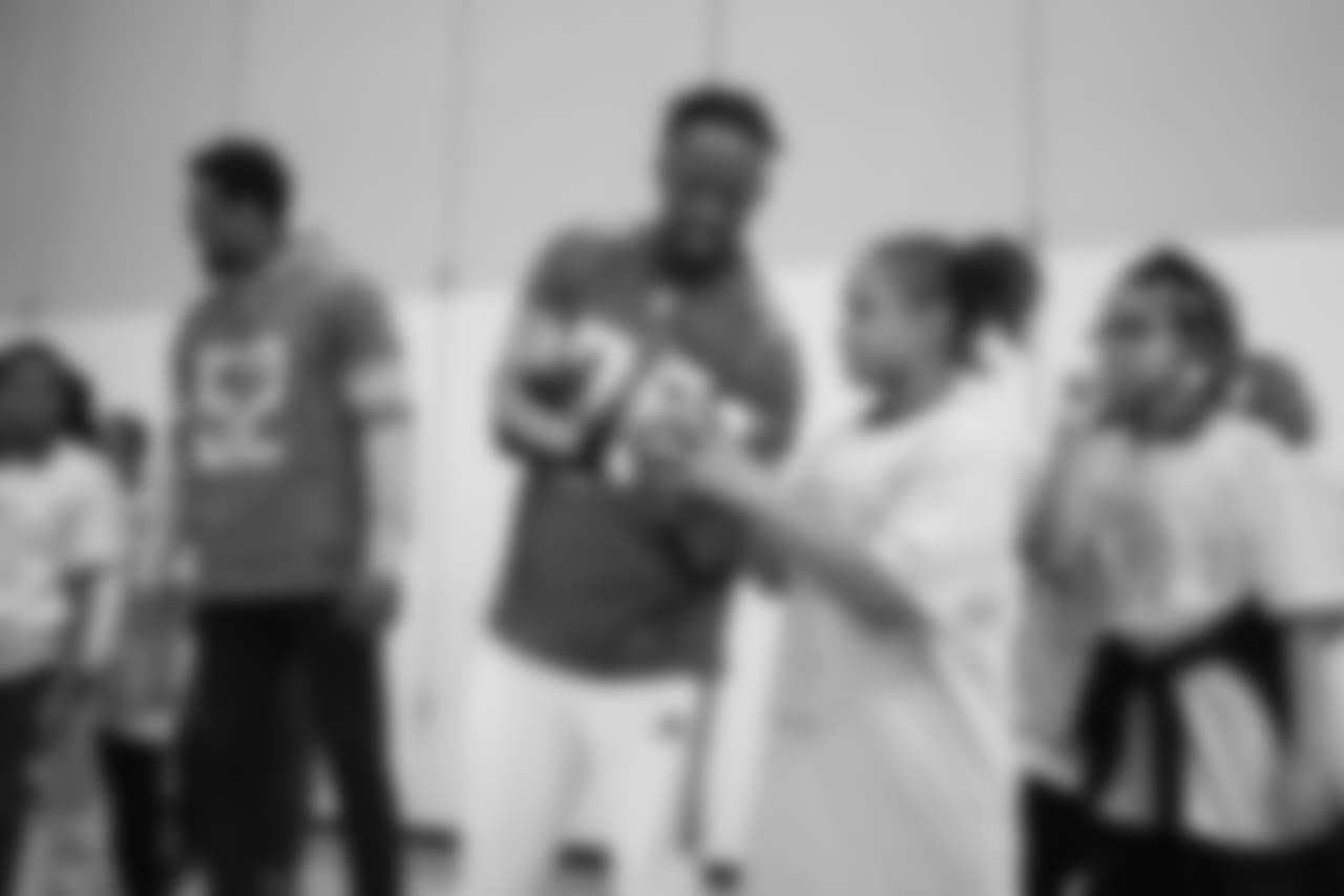 Detroit Lions cornerback Nevin Lawson (24) gives some throwing tips at a real players don't bully assembly with Playworks at Hutchinson Elementary School on Tuesday, Oct. 22, 2018 in Detroit.