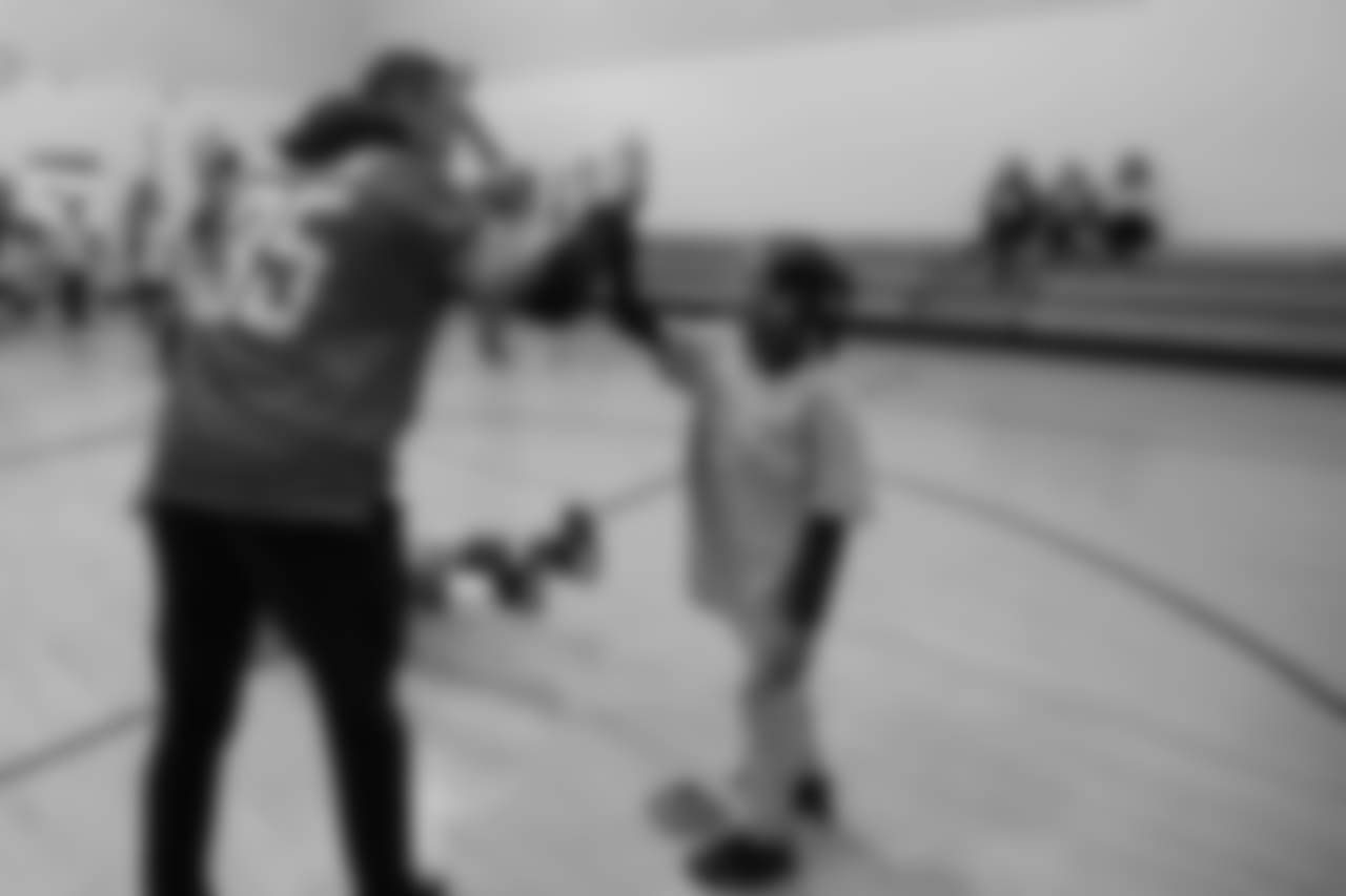 Detroit Lions safety Miles Killebrew (35) high fives a student at a real players don't bully assembly with Playworks at Hutchinson Elementary School on Tuesday, Oct. 22, 2018 in Detroit.