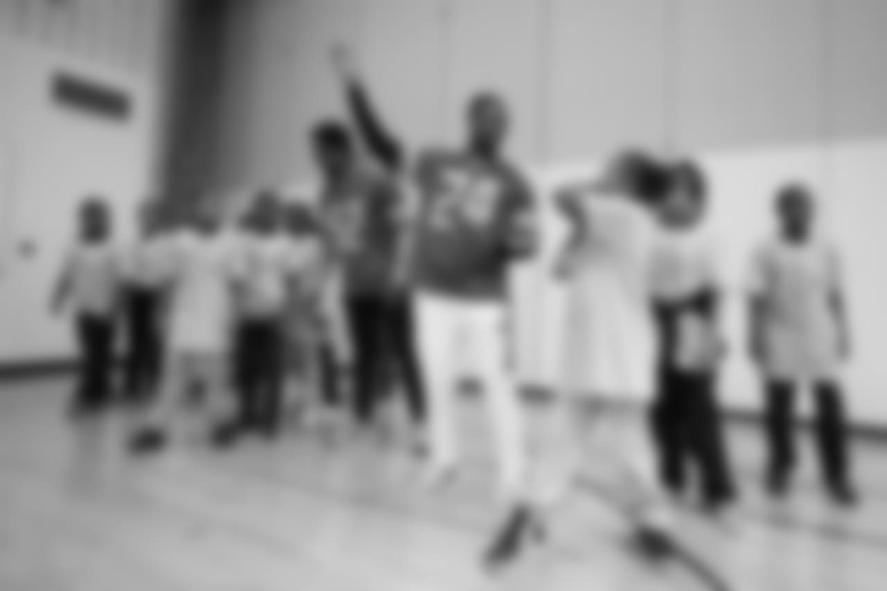 Detroit Lions cornerback Nevin Lawson (24) gives some throwing tips at a real players don't bully assembly with Playworks at Hutchinson Elementary School on Tuesday, Oct. 22, 2018 in Detroit.