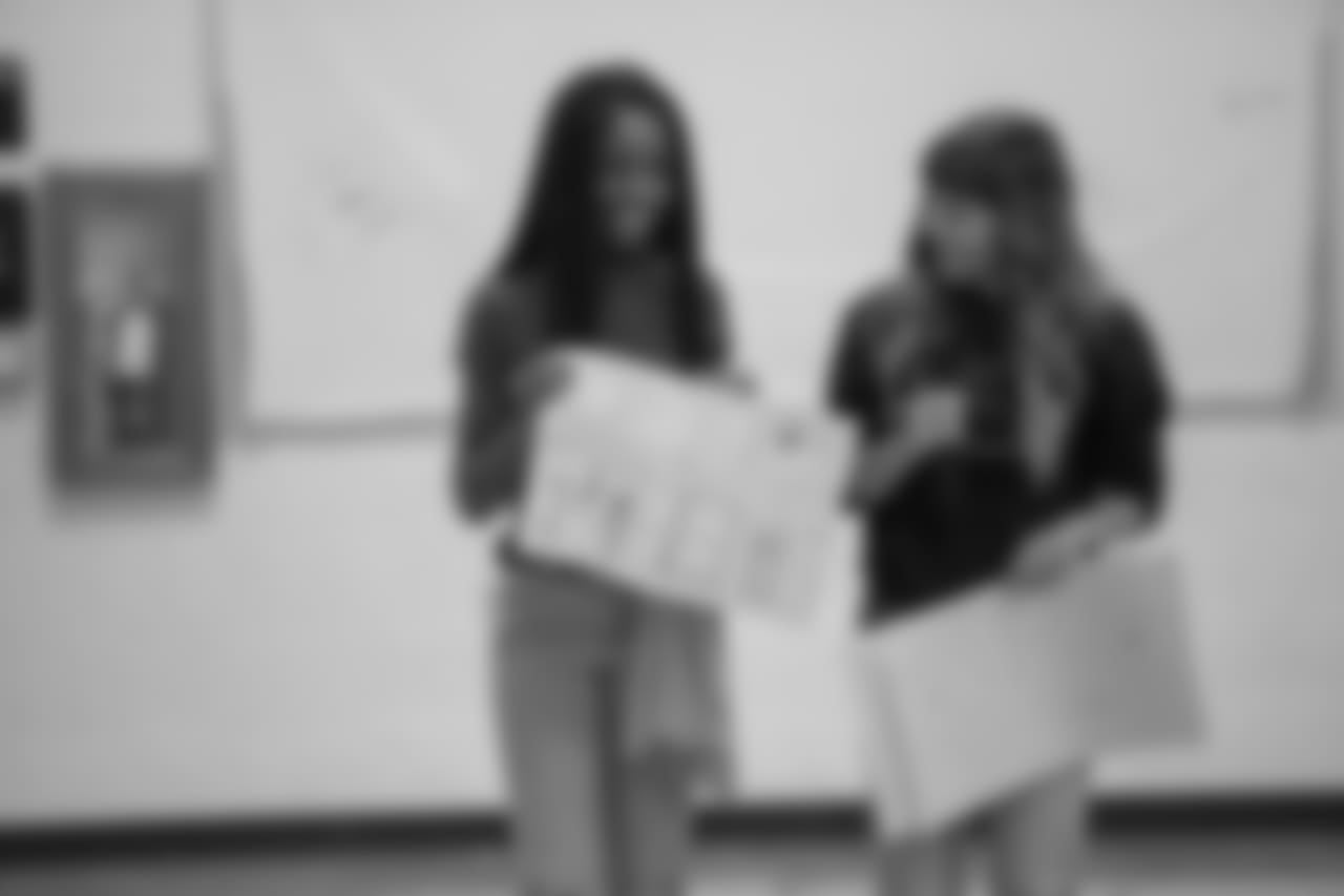Students show off their winning posters at a real players don't bully assembly with Playworks at Hutchinson Elementary School on Tuesday, Oct. 22, 2018 in Detroit.