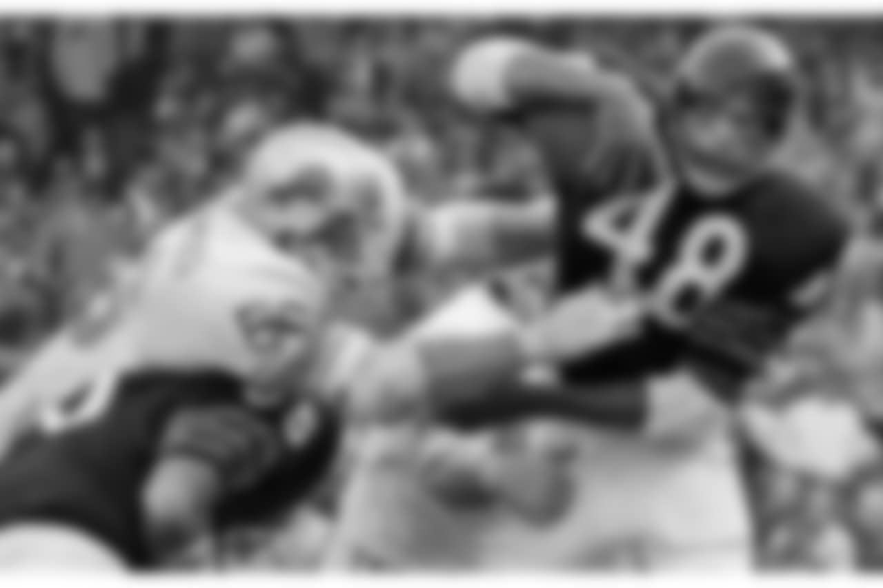 Chicago Bears back Ron Smith (48) seems surprised that a couple of Detroit Lions players want to tackle him in the third quarter, Sunday, Oct. 25, 1970 in Chicago. He broke away from Lions' guard Bob Kowalkowski (66, left) and back Bobby Williams, rear, for a punt return of 21 yards before being downed by back Ed Mooney, not shown. The Lions won 16-10. (AP Photo/Jim Palmer)
