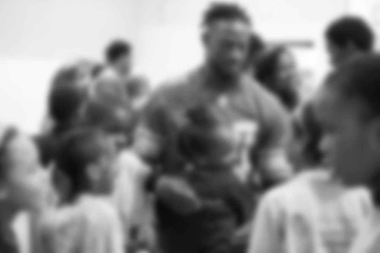Detroit Lions cornerback Nevin Lawson (24) hugs a student at a real players don't bully assembly with Playworks at Hutchinson Elementary School on Tuesday, Oct. 22, 2018 in Detroit.