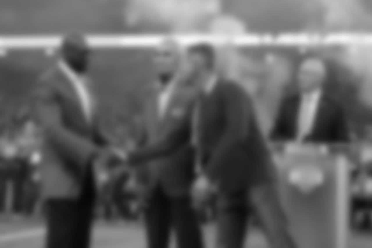 Herman Moore shakes hands with George Karras, who represented his late father, Alex, during the Pride of the Lions induction ceremony during halftime of a NFL football game against the Seattle Seahawks on Sunday, Oct. 28, 2018 in Detroit. (Detroit Lions via AP).