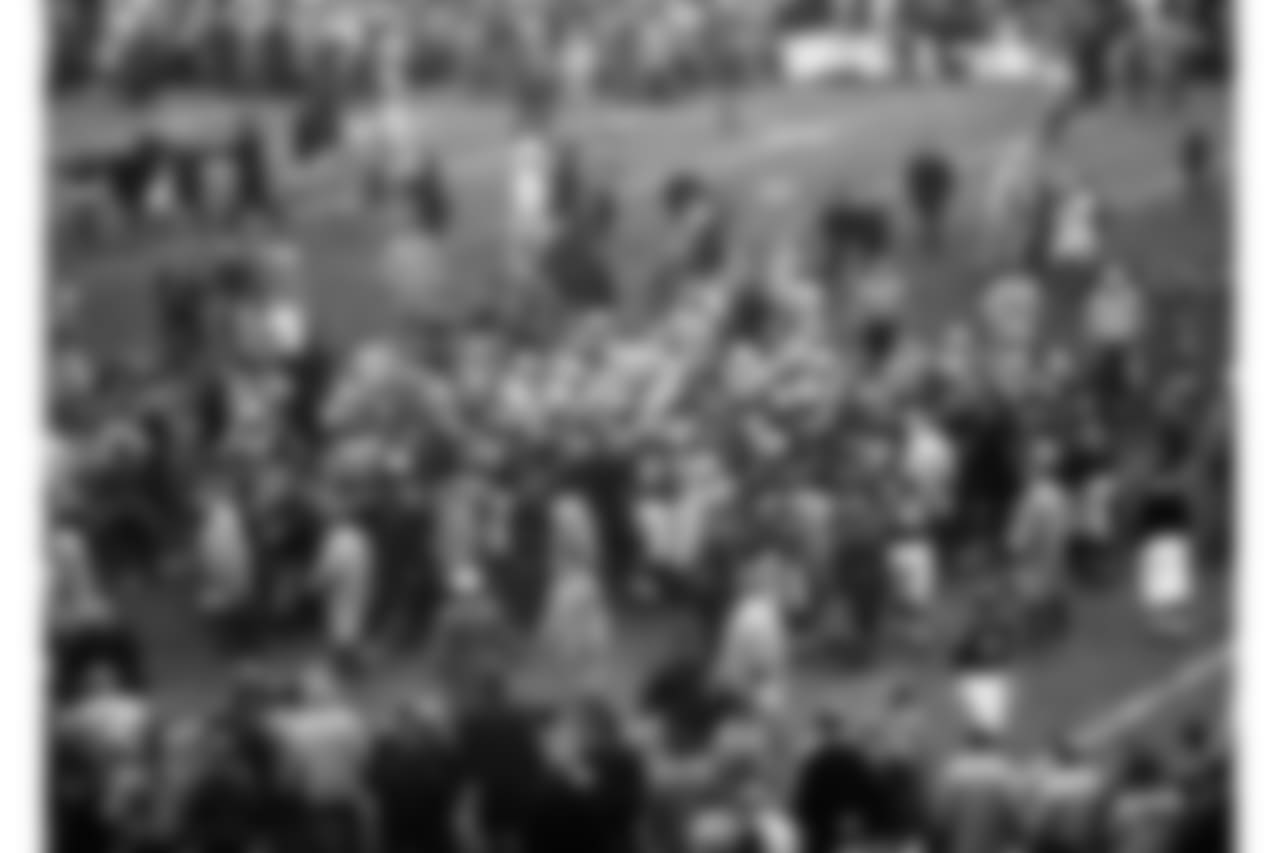 Both players and spectators pile onto the field as a free-for-all brawl erupted in the late minutes of the Chicago Bears-Detroit Lions Western Division crown game, Dec. 16, 1956 in Chicago. The game was marred by one penalty after another, as the Chicago Bears won, 21-38. (AP Photo/Paul Cannon)
