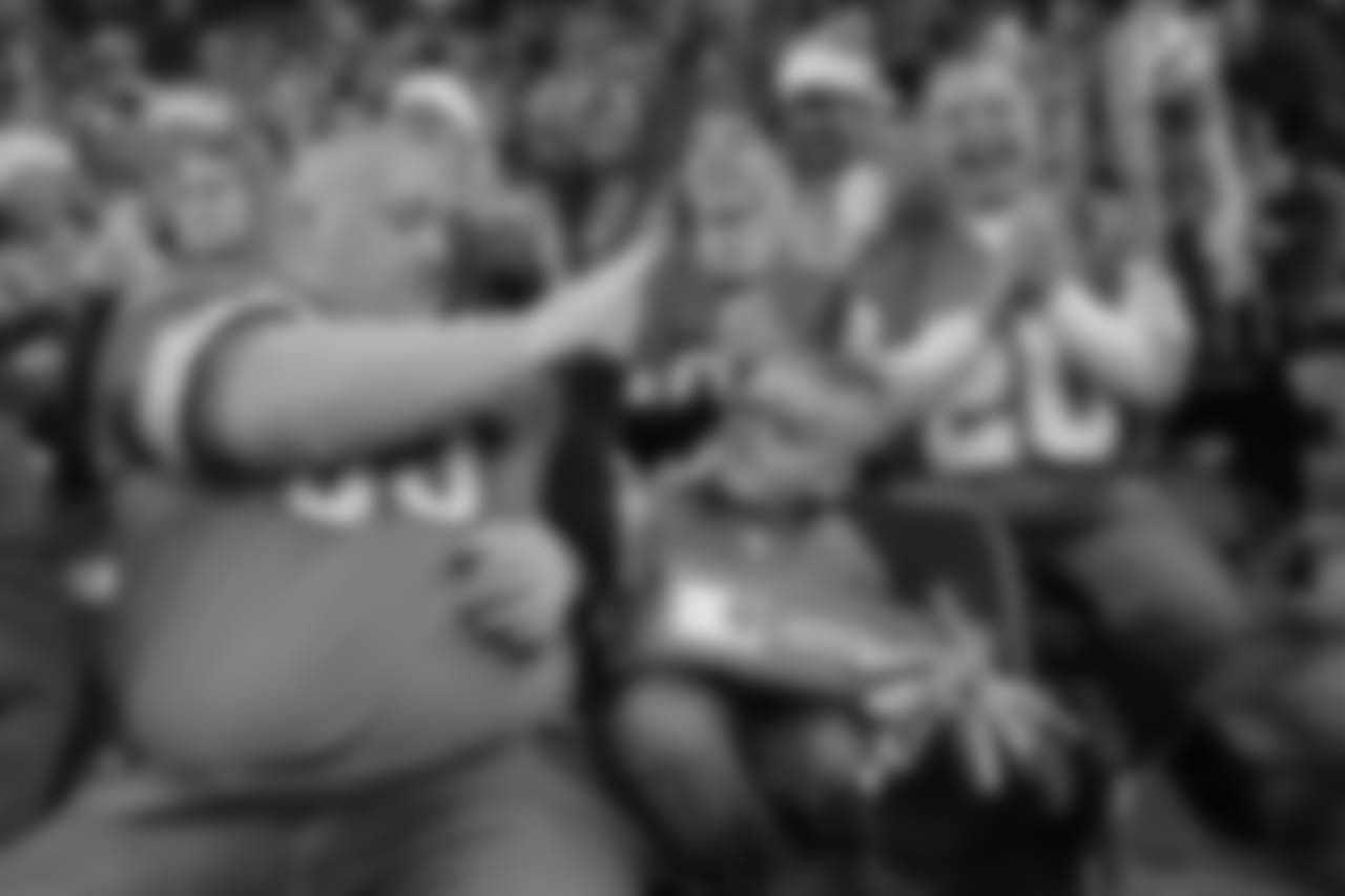 A fan receives a surprise from Santa Claus during a NFL football game against the Minnesota Vikings on Sunday, Dec. 23, 2018 in Detroit. (Detroit Lions via AP).