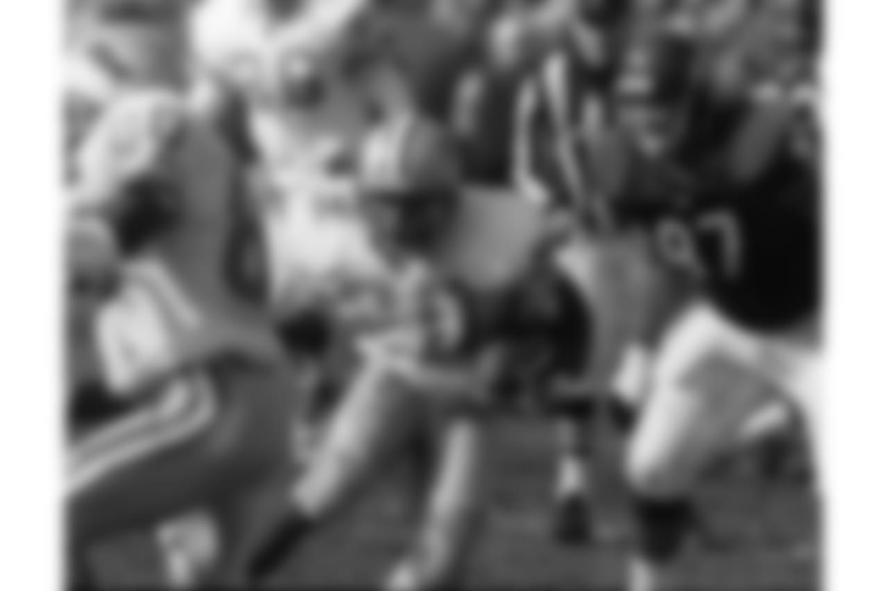 Detroit Lions running back Barry Sanders picks up yardage with blocking help from Brett Perriman (80) as the Chicago Bears' Chris Zorich gives chase in the first quarter of the Lions 24-17 win, Sunday, Nov. 19, 1995, in Chicago. Sanders rushed for 120 yards on 24 carries to join Eric Dickerson as the second back in NFL history to rush for 1,000 yards in each of his first seven seasons. (AP Photo/Fred Jewell)