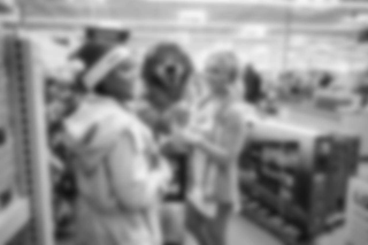 Roary and Detroit Lions Cheerleader Alexis shop with a student from Detroit Lions Academy at Shop with a Lion at Meijer on Tuesday, Dec. 4, 2018 in Detroit.