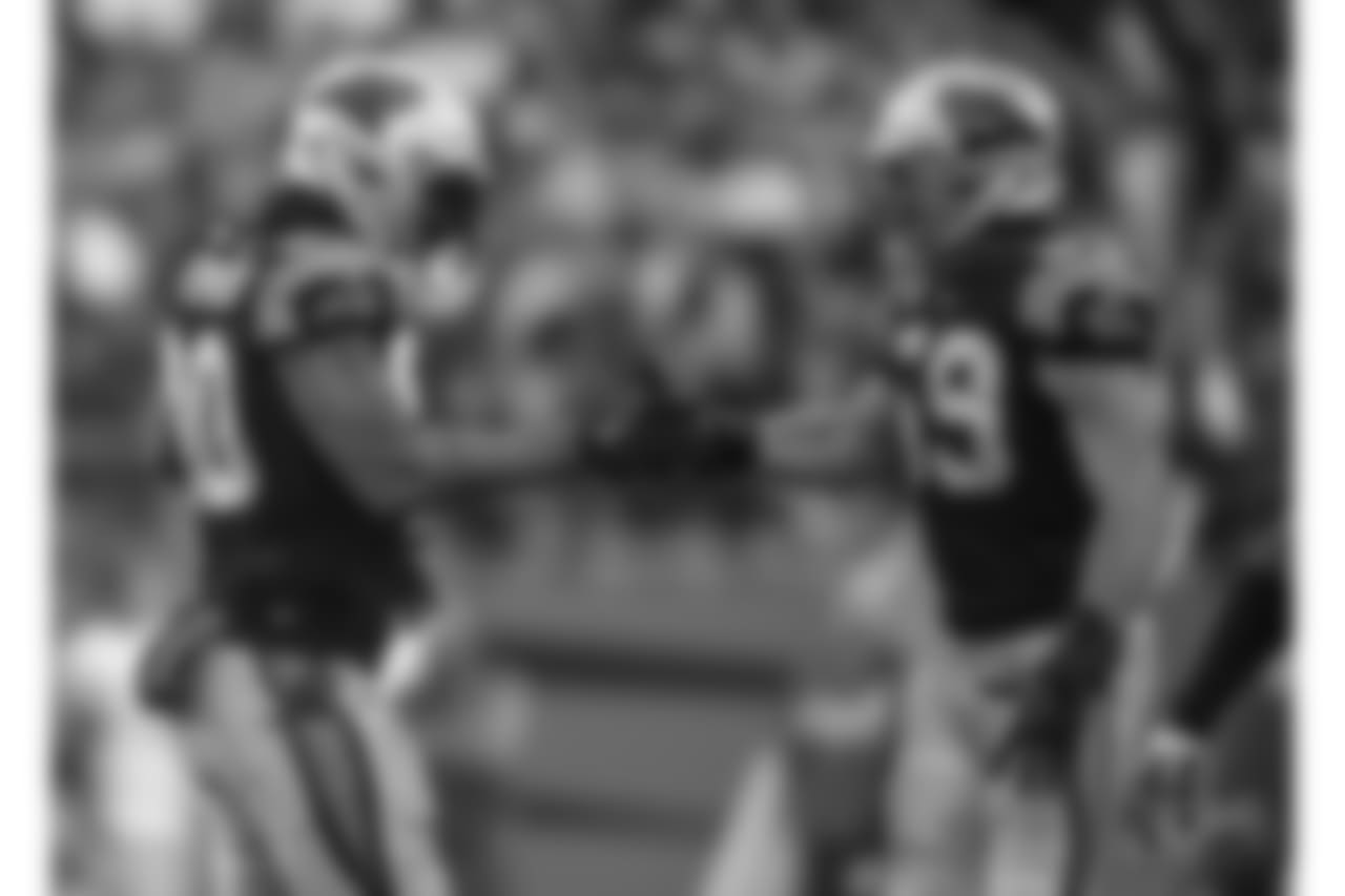 Julius Peppers and teammate Luke Kuechly.