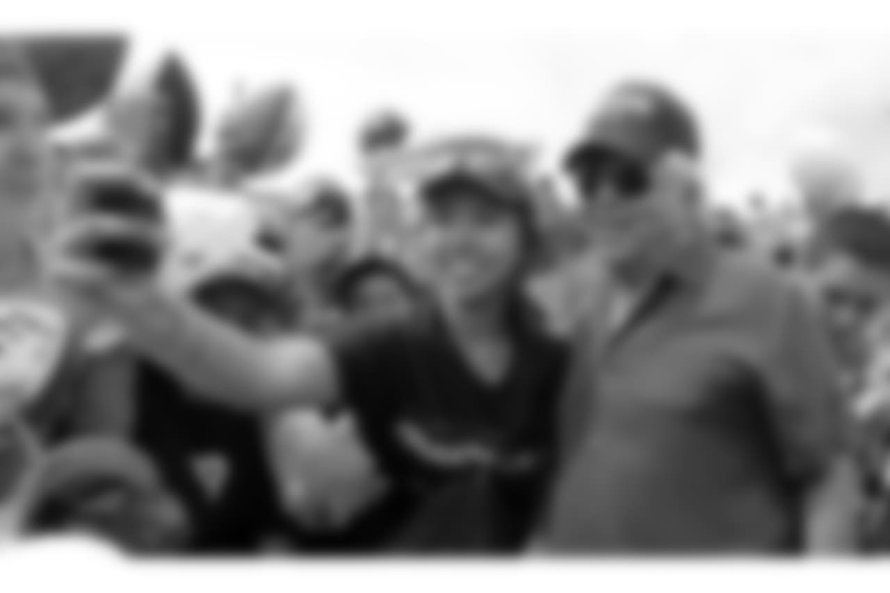 New England Patriots owner Robert Kraft takes a selfie with a fan after an NFL football training camp in Foxborough, Mass., Thursday, July 30, 2015. (AP Photo/Charles Krupa)