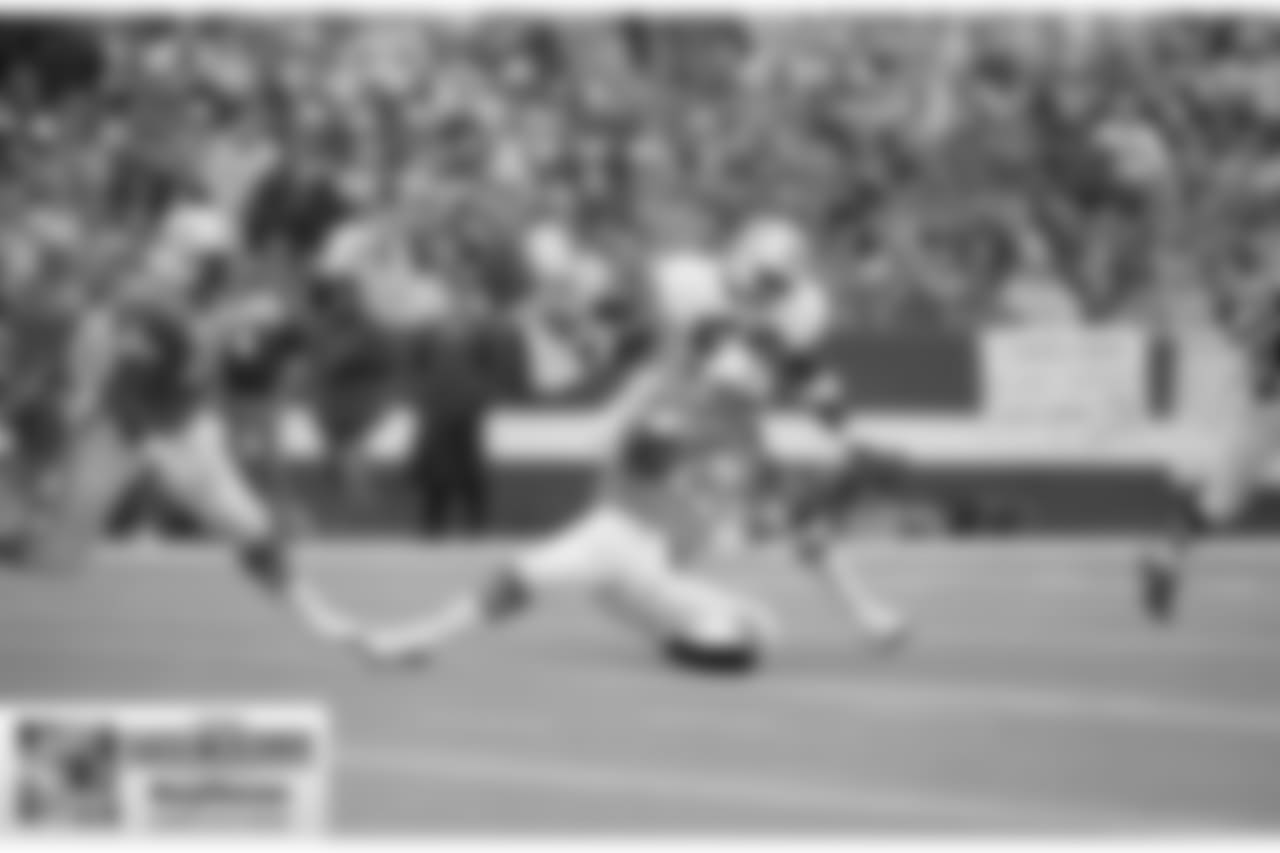 Dan Marino, Miami Dolphins quarterback, hits the ground as New England's Andre Tippett puts on the pressure, Nov. 3, 1985. (AP Photo/Charles Krupa)
