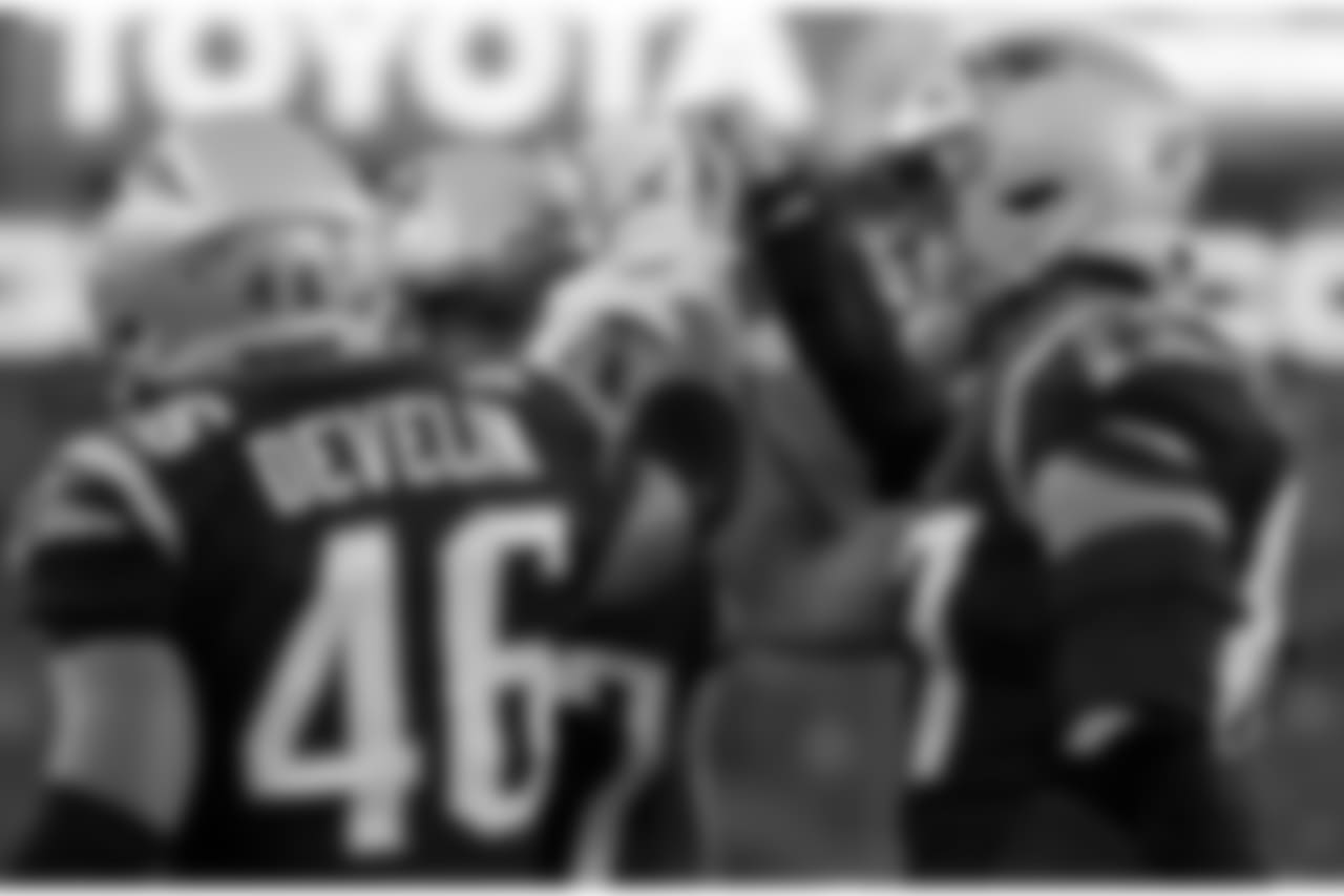 New England Patriots players huddle with fist pumps before an NFL football game against the Minnesota Vikings, Sunday, Dec. 2, 2018, in Foxborough, Mass. (AP Photo/Elise Amendola)