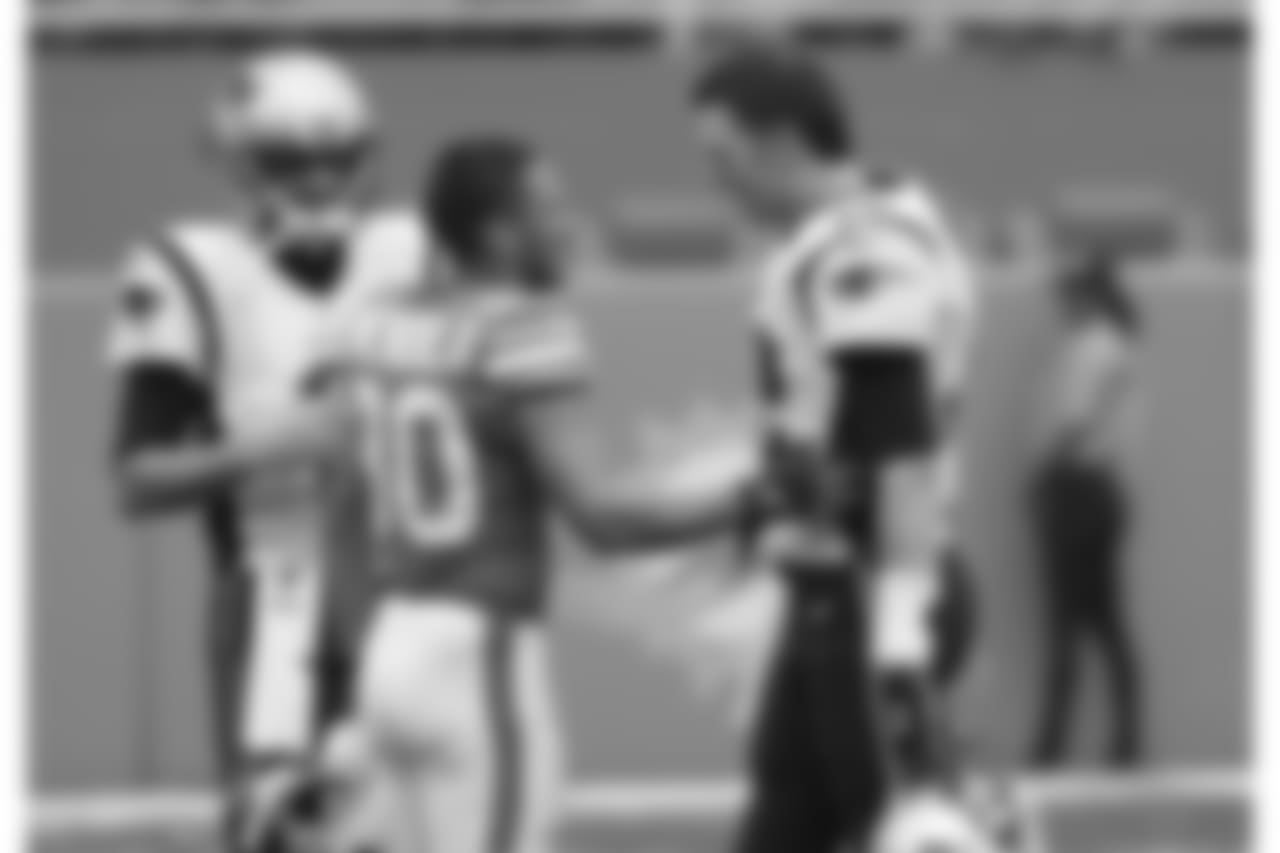 Miami Dolphins wide receiver Danny Amendola (80) greets New England Patriots quarterback Tom Brady (12), before an NFL football game, Sunday, Dec. 9, 2018, in Miami Gardens, Fla. Behind them is New England Patriots quarterback Brian Hoyer (2). (AP Photo/Wilfredo Lee)